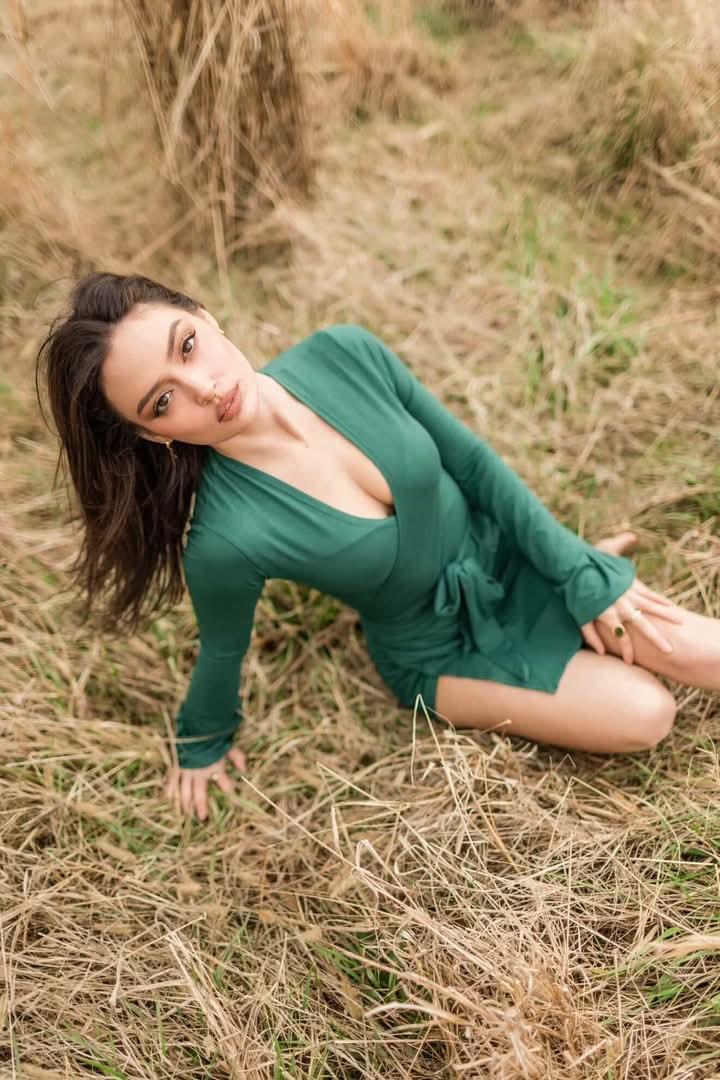 Green dress portrait seated in the grass